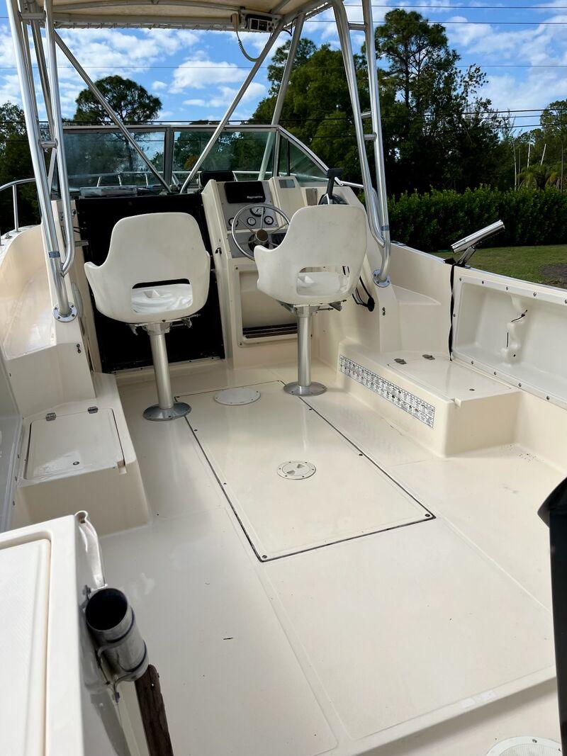 The same boat cockpit and helm after a full detail, with clean bright vinyl and surfaces