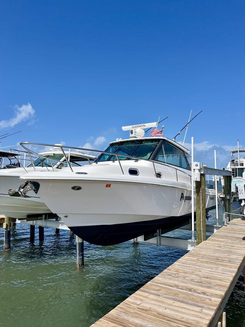 Express cruiser detailed on a boat lift at a Jupiter dock